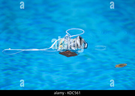 Underwater photo camera housing floating in a swimming pool Stock Photo