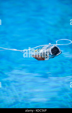 Underwater photo camera housing floating in a swimming pool Stock Photo