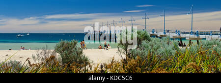 Families enjoying sandy beach on sunny day at Palm Beach Jetty, Rockingham. Stock Photo