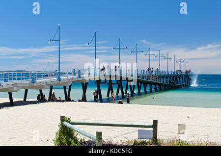 Families enjoying sandy beach on sunny day at Palm Beach Jetty, Rockingham. Stock Photo