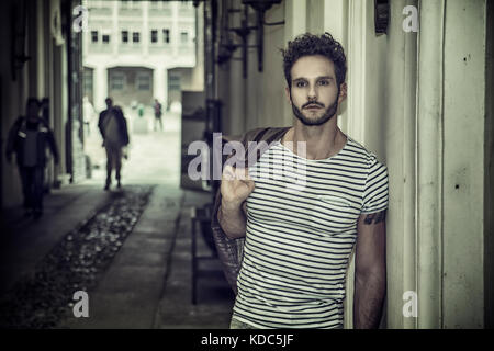 Attractive young man outdoor wearing leather jacket Stock Photo
