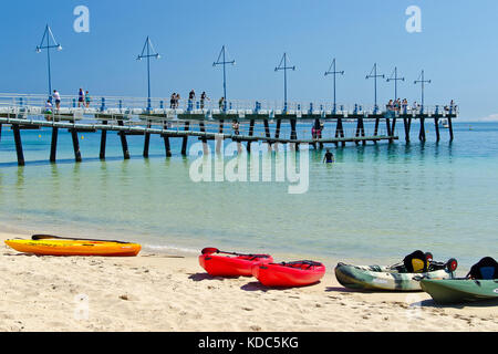 Families enjoying sandy beach on sunny day at Palm Beach Jetty, Rockingham. Stock Photo