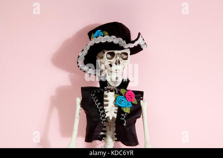 Mexican skeleton celebrating el dia de los muertos on a vibrant pop background. Minimal color still life photographyf.asMinimal color still life photo Stock Photo