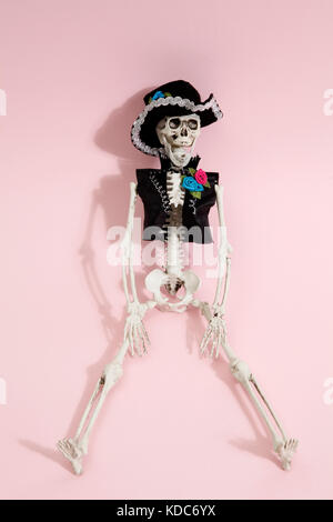 Mexican skeleton celebrating el dia de los muertos on a vibrant pop background. Minimal color still life photographyf.asMinimal color still life photo Stock Photo