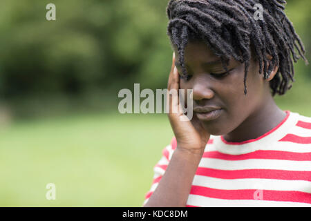 Outdoor Shot Of Stressed Teenage Girl Stock Photo