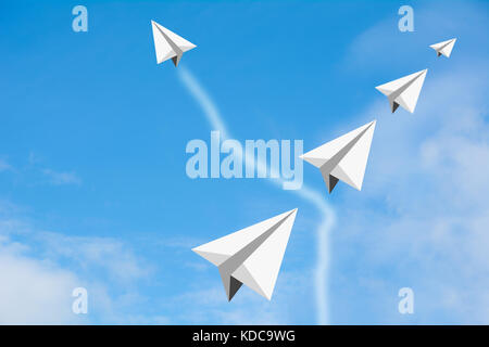 Paper airplane as a leader among another airplane with another one, leadership, teamwork on blue sky background. Stock Photo