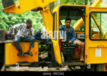 Two construction workers siting on crane Stock Photo
