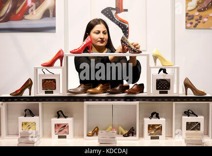 Chocolatier Azra Sadiq completes her display of Louis Vuiton design inspired chocolate shoes at The Chocolate Show, at Kensington Olympia, London. Stock Photo