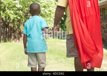 African American little boy super hero playing outside. Stock Photo