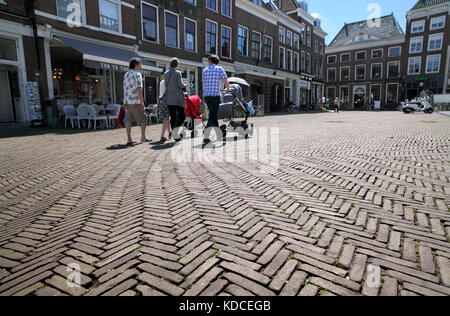 Red brick paving with a herringbone pattern in Delft's pedestrianised Market Square. Stock Photo