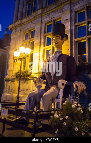 Giant effigy of the Elector of Lamartine, Electeur de Lamartine outside the  town hall,  Bergues, Nord Pas de Calais, Hauts de France, France at night Stock Photo