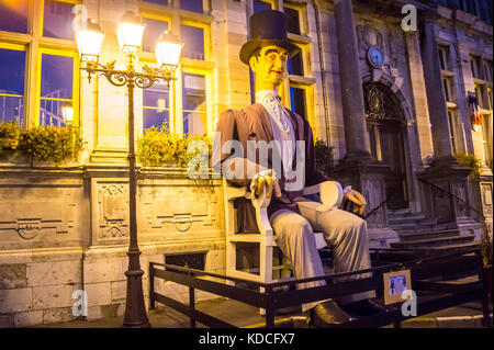 Giant effigy of the Elector of Lamartine, Electeur de Lamartine outside the  town hall,  Bergues, Nord Pas de Calais, Hauts de France, France at night Stock Photo