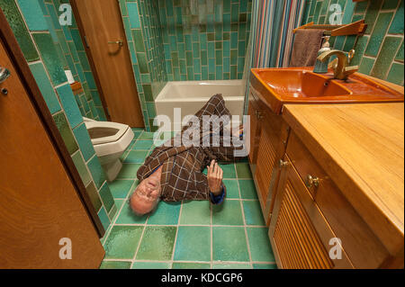 Senior man falling in his bathroom Stock Photo