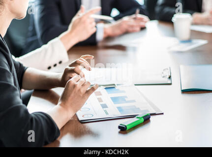 Image of business partners discussing documents and ideas at meeting Stock Photo