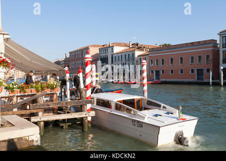 Water taxi offloading tourists at a hotel in Cannaregio on the Grand Canal in evening light Stock Photo