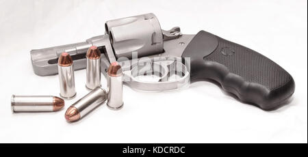 An unloaded 44spl revolver with the cylinder opened and it's bullets outside the gun Stock Photo