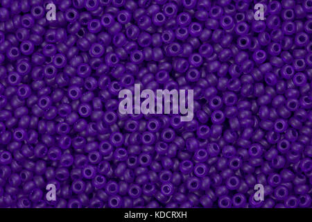 Bright purple seed beads background. Stock Photo