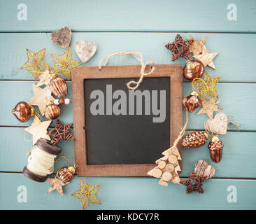Rustic christmas decorations and ornaments on blue wooden background Stock Photo