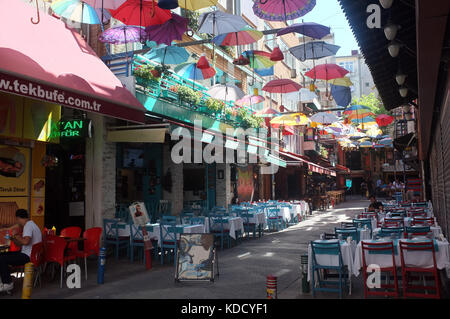 Istanbul, Turkey - September  2, 2017: Small street decorated with floating colourful umbrellas in Istanbul, Turkey Stock Photo