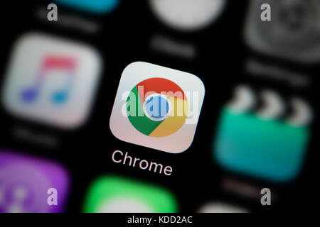 A close-up shot of the logo representing Google Chrome app icon, as seen on the screen of a smart phone (Editorial use only) Stock Photo