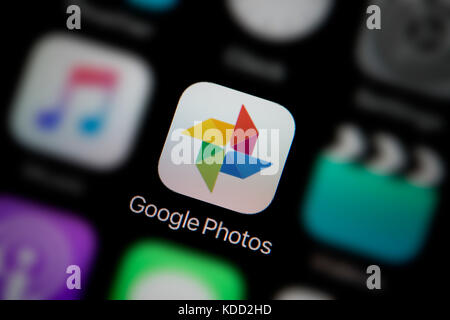 A close-up shot of the logo representing Google Photos app icon, as seen on the screen of a smart phone (Editorial use only) Stock Photo