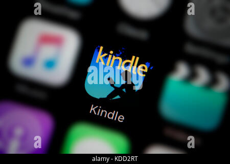 A close-up shot of the logo representing Kindle app icon, as seen on the screen of a smart phone (Editorial use only) Stock Photo