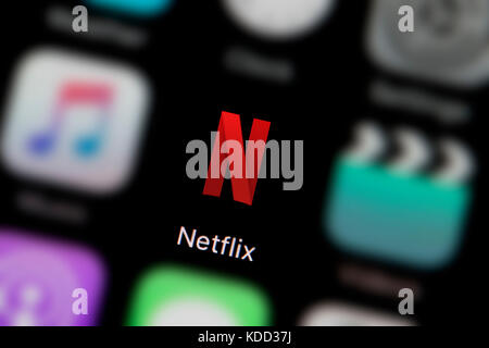 A close-up shot of the logo representing Netflix app icon, as seen on the screen of a smart phone (Editorial use only) Stock Photo