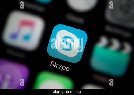 A close-up shot of the logo representing Skype app icon, as seen on the screen of a smart phone (Editorial use only) Stock Photo