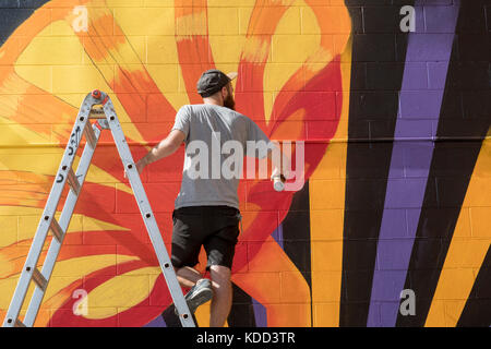 Grand Rapids, Michigan - A man paints during the annual ArtPrize competition. Stock Photo