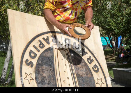 Grand Rapids, Michigan - A man burns a design on wood during the annual ArtPrize competition. Stock Photo