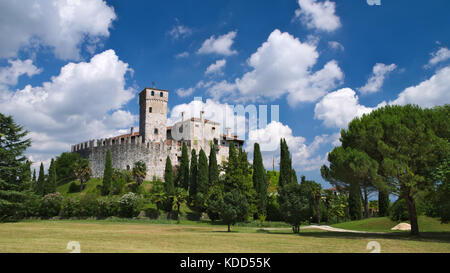 Cloudy sky in a sunny day over the medieval Villalta castle, Fagagna, Friuli, Italy Stock Photo