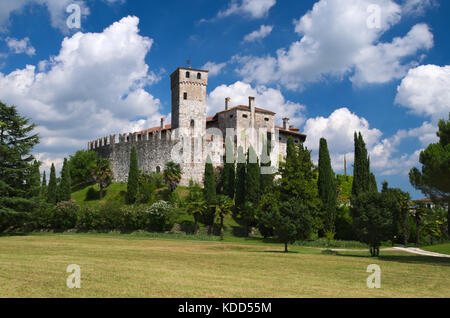 Cloudy sky in a sunny day over the medieval Villalta castle, Fagagna, Friuli, Italy Stock Photo