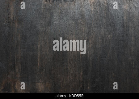 Wood texture, dark painted scratched plywood board background Stock Photo