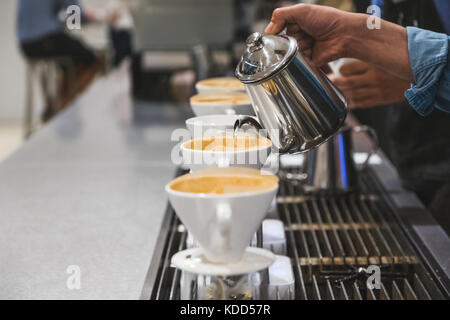 A barista prepares coffee Stock Photo