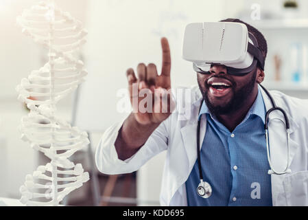 Young medical worker wearing VR goggles at work Stock Photo
