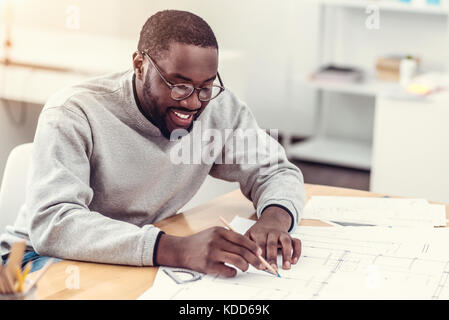 Hard working technical professional drawing at work Stock Photo