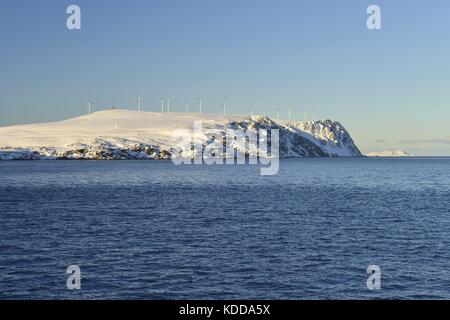 Snow-covered rock island Havøya with a wind farm on it under a clear blue sky, 7 March 2017 | usage worldwide Stock Photo