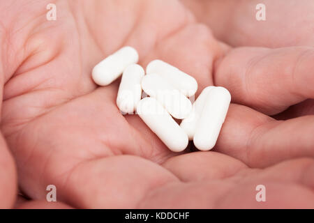 Close-up Of A Pills On Person's Palm Stock Photo