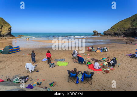 People enjoying the sunny weather on Llangrannog beach Stock Photo