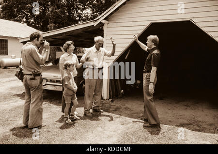 A local newspaperman photographs Governor Carter as he campaigns door-to-door in the rural South. Stock Photo