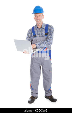 Portrait Of A Male Happy Architect Using Laptop On White Background Stock Photo