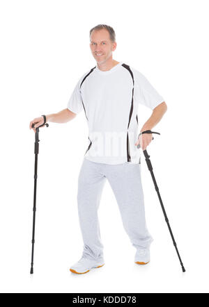 Portrait Of Man Walking With Hiking Pole Over White Background Stock Photo