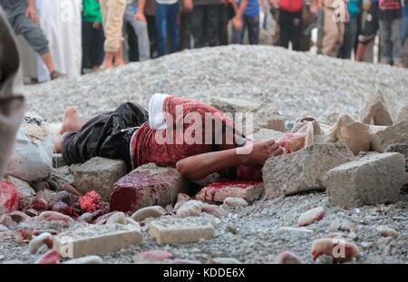 EDITORS NOTE: GRAPHIC CONTENT. Undated ISIS propaganda image showing a man killed by stoning for sodomy during a public execution in Raqqa, Syria.