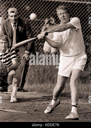 Carter at bat during a softball game at Plains High School. The umpire is consumer advocate and future five-time presidential candidate Ralph Nader. T Stock Photo