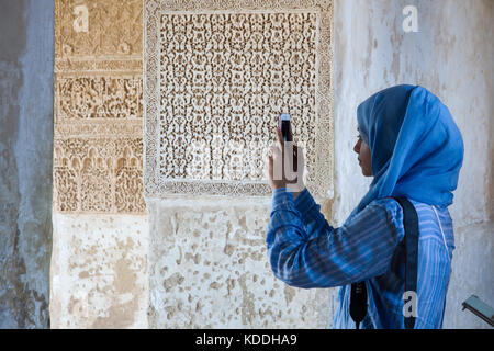 Alhambra Granada interior scene, muslim woman visiting the last one Arabic architecture building in Europe. Spain destination. Stock Photo