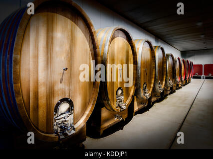 big barrels of ageing wines in nortern italy Stock Photo