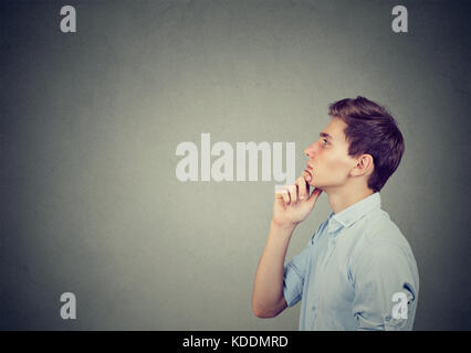 Thoughtful young man making up his mind Stock Photo