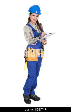 Portrait Of Young Female Worker Writing On Clipboard Stock Photo