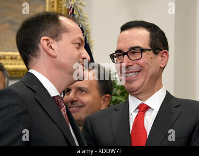 Washington, DC, USA. 12th Oct, 2017. United States Secretary of Labor Alex Acosta and US Secretary of the Treasury Steven Mnuchin speak prior to the arrival of US President Donald J. Trump who will sign an Executive Order to promote healthcare choice and competition in the Roosevelt Room of the White House in Washington, DC on Thursday, October 12, 2017. The President's controversial plan is designed to make lower-premium health insurance plans more widely available. Credit: MediaPunch Inc/Alamy Live News Stock Photo