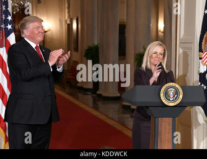 Washington, DC, USA. 12th Oct, 2017. United States President Donald J. Trump, left, applauds after announcing he will name Principal Deputy White House Chief of Staff Kirstjen Nielsen, right, as Secretary of Homeland Security in the East Room of the White House in Washington, DC on Thursday, October 12, 2017. If confirmed, Nielsen will replace Acting US Secretary of Homeland Security Elaine C. Duke, who has been in that position since General John F. Kelly, USMC (Retired) resigned to become White House Chief of Staff. Credit: MediaPunch Inc/Alamy Live News Stock Photo